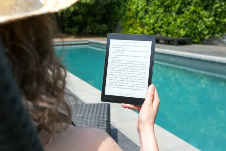 Person reading an eBook by a pool