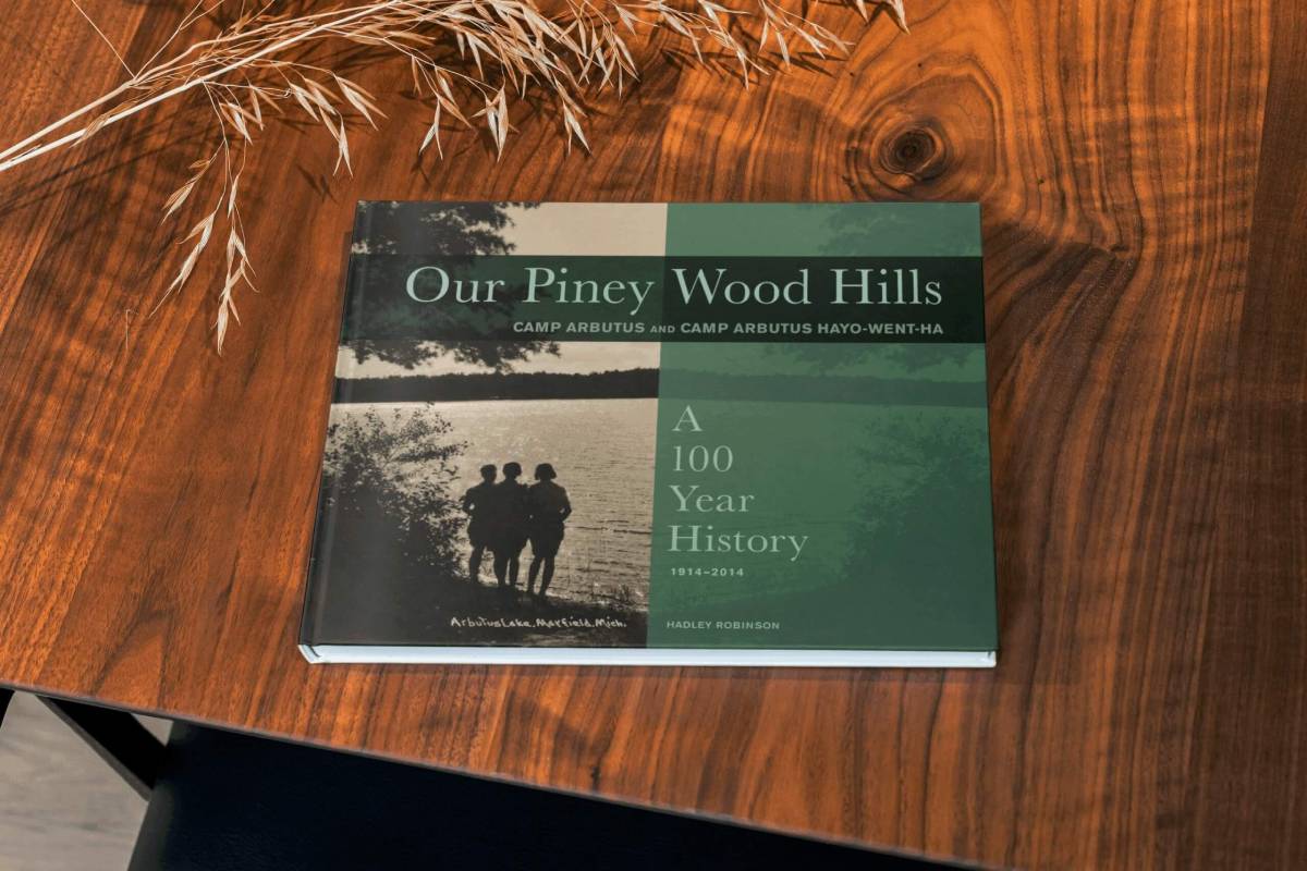 A copy of Our Piney Wood Hills, a 100-year history book, on a wooden table